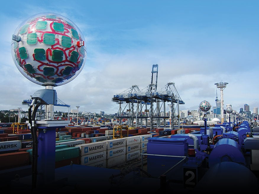 A row of Locata VRay Orb60 antennas atop Konecranes A-STRAD machines stretch into the distance toward Auckland’s business district. (Photo: David Small/Locata)